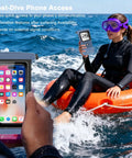 Diver floating with fully submersible diving phone case with full touchscreen access near ocean, using phone in IPX8 housing.