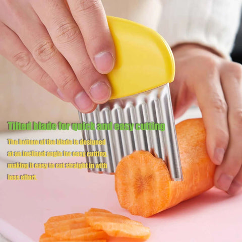 Front view of yellow-handled stainless steel crinkle cutter slicing a carrot on a pink cutting board