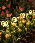 6 Pack Solar Pathway Lights Outdoor LED Garden Lights illuminating a garden walkway among tulips at night with a warm glow.