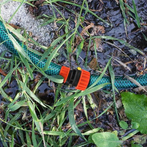 Two Pack One Half To Three Quarter Inch Garden Hose Repair Menders Connectors Adapters For Quick Leak Proof Repair And Extension Of Your Water Hose With Durable ABS Plastic Construction connecting hoses in a garden setting