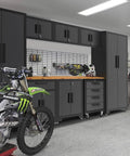 Nine Piece Steel Garage Cabinet Set With Locking Storage and Rolling Chest Includes Tall Cabinets Base Cabinets Wall Cabinets Four Drawer Cabinet on Casters for Easy Tool Organization in Black and Grey installed in a garage.