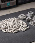 Cylinder Shaped Silicon Carbide Tumbling Media 440g Pro Grade Deburring And Self Loss Prevention For Industrial Finishing, Heavy Duty Vibratory Bowl Polisher For Ceramic Workpieces, white cylinders on mat