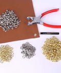 1203Pcs Grommet Eyelet Pliers Tool Kit With 1/4 Inch Eyelets And Washers, showing pliers on fabric with silver and gold eyelets
