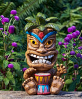 Colorful solar powered tiki statue light for garden, patio, and backyard decor, 10 inch tall, surrounded by purple flowers