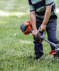 Child using 223L Toy Trimmer With Realistic Sounds And Light Up Trimmer Line For Kids Ages 3 And Up A Kid Friendly Weed Eater Play Tool