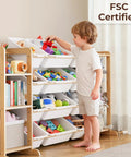 Child using Ultimate Toy Storage Organizer With Bookshelf And 12 Removable Bins For Kid's Playroom, shown in living room