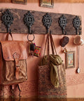 Six Pack Rock Solid Cast Iron Wall Hooks With Rustic Indian Leaf Design Heavy Duty Matte Black Finish displaying bags and keys.