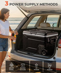 Massive 69 Quart 12V Portable Refrigerator And Freezer Cart Riding On Tough Off Road Wheels in car trunk with power options.