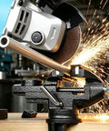 Badass 3.2 Inch Bench Vise With Fully Swiveling 360 Rotation And Grippy Soft Jaws holding metal, sparks from cutting visible.
