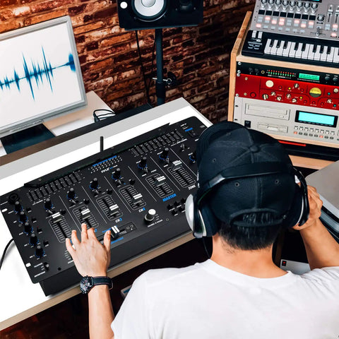 Person using Six Channel Bluetooth DJ Mixer Controller With LED Illumination And Digital Audio Mixing System in studio setup