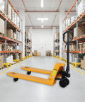 Apollolift Hydraulic Pallet Jack Truck, 5500 Lb Capacity in a warehouse aisle with boxes and storage shelves.