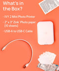 Ivy 2 Mini Photo Printer For IPhone And Android Zero Ink ZINK Tech Print Sticky Back Photos Directly From Your Smartphone On The Go No Ink Needed Quick Colorful Prints In Pure White Finish with accessories on orange background.