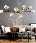 9-Light Sputnik Chandelier In Black And Gold, Dope Mid-Century Modern Crystal Branch Pendant For Your Dining Room And Living Room, 9 Warm White G9 Bulbs Included hanging above a modern living room setup with a sofa and coffee table.