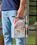 Indoor Insect Killer Spray With Wand Builds A Tough Shield Against Roaches, Ants, Spiders, Ticks And Fleas Ready To Use Crackdown On Household Pests 1 Gallon held by a person in a casual setting.