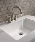 Porter Two Handle Centerset Bathroom Faucet In Brushed Nickel With Mid Arc Spout running water into sink