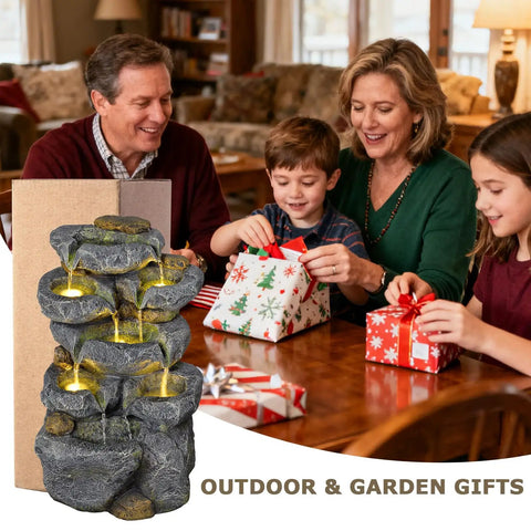 Family sitting at a table with Solar Powered 5 Tier Rock Water Fountain With LED Lights displayed, gift wrapping around.