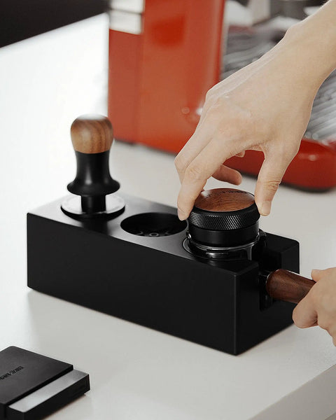 Hand using Walnut 4 In 1 Espresso Knock Box And Tamping Station With Portafilter Holder Tamper Holder And Distributor Holder