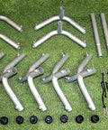 Parts of Outdoor Indoor Batting Cage Frame Kit 55 X 14 X 12 Inches With 1-1/2 Inch Steel Frame Corners laid out on grass