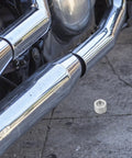 Two Piece Motorcycle Cam Chain Tensioner Adjuster Kit For Suzuki Cruisers showing steel regulator near chrome exhaust.