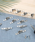 Pack Of 12 Push Pull Sliding Window Rollers Three Eighths Inch Metal Wheel With Axle For Sliding Doors And Windows displayed on fabric