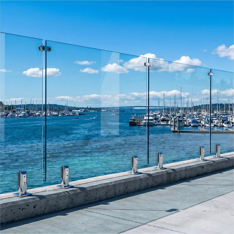 Top Tier Frameless Tempered Glass Railing Kit For Outdoor Decks, 44 Inch Height, showing clear glass panels and stainless steel posts near water.