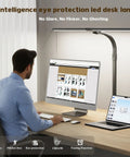 Man working at desk with Insanely Bright 24W LED Desk Lamp With Dual Swing Arm Heads, computer and laptop