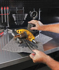 Premium Oil Absorbent Mat Pads 15 x 20 Inches used in workshop to clean oil from car parts on metal workbench