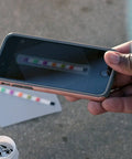 Person using smartphone to scan Six Way Pool Water Test Strips For Rapid Chemical Readings With Seamless App Sync To Keep Your Backyard Hangout Sparkling All Summer Long Without Any Headaches Or Sticker Shock From Costly Store Visits.