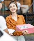 Woman holding light pink Self Seal Poly Mailer Bags, 100 Pack, Fourteen Point Five By Nineteen Inch Tearproof Shipping Envelopes