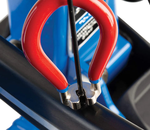 Four Sided Spoke Wrench For Nipples 3.23 Millimeter 0.13 Inch Red Wheel Truing Tool in use on bicycle rim