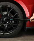 Beefy 1/2-Inch Drive Click Torque Wrench With 25-250 Ft-Lb Range in use on car wheel, durable Cr-V ratchet head visible