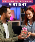 Man giving woman a basket sealed with clear PVC film featuring strawberries, emphasizing airtight packaging.
