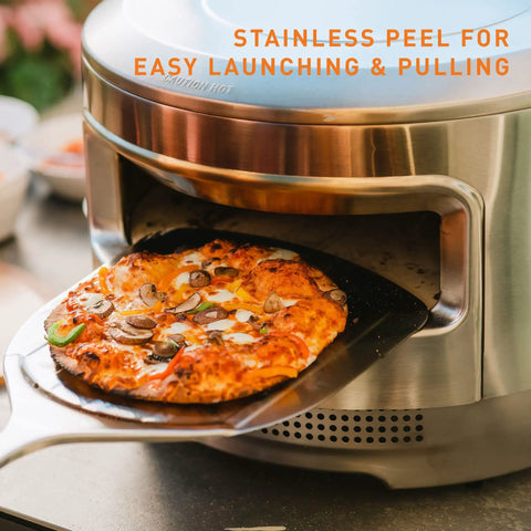 Pizza Oven Starter Bundle With Stainless Steel Outdoor Pizza Maker And Wood Fired Assembly, Pizza Stone, Thermometer, Peel, And Cutter For Backyard Pizza Nights And A Crust Twice As Crisp with pizza on peel