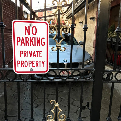 Tough As Nails No Parking Private Property Sign 12 X 18 Inch Heavy Duty Aluminum Sheet mounted on a gate with a parked car behind it.
