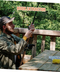 Stainless steel fishing detacher tool held by a man on a wooden deck; tackle box visible