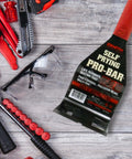 Self Prying Pro Bar Salvage Wrecking And Demolition Tool with black steel body and red handle on wood background.
