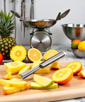 V Shape Pineapple Eye Remover Tool With Multipurpose Clip Stainless Steel Peeler for home kitchen on cutting board with sliced fruit