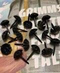 Premium 7/16 Inch Upholstery Tacks For Furniture Fix Ups, black decorative nailheads on a patterned surface.