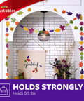 Repositionable Wall Decor Clip Kit With 8 Spring Clips And 24 Mini Squares, White Finish, displayed with autumn leaf garland