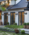 Outdoor Dusk To Dawn Barn Light With Hammered Metal Shade And Antique Brass Finish, Porch Wall Sconce For Farmhouse Style, Photocell Sensor Auto On At Dusk Auto Off At Dawn, No Switch Needed Easy Install illuminating a modern patio.