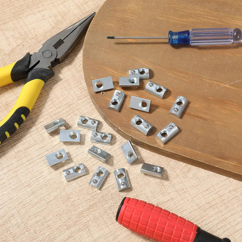 Twenty Pack 1/4-20 T Slot Nuts With Ball Spring for 10 Series Aluminum Extrusion Rails, shown with tools for CNC DIY Projects.