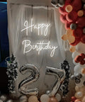 Lit Two Line Happy Birthday Neon Sign LED Light For Party Backdrop And Photo Booth Vibes, surrounded by balloons