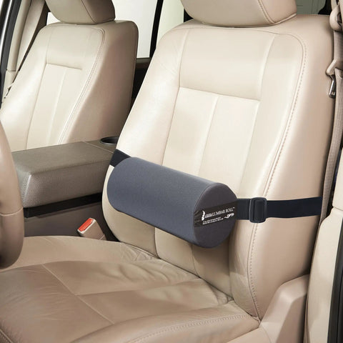 The Original McKenzie Lumbar Roll Standard Density Low Back Support Pillow secured on car seat for ergonomic support.