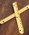 Antique Bronze Decorative Hinges for Wooden Boxes and Cabinets 2 Pack Butt Hinges 100mm by 9mm on a wooden surface