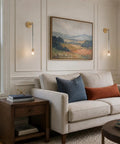 XYDikssn Crystal Wall Sconces, Brushed Gold Brass Wall Lights with Clear Crystal Glass beside a sofa in a cozy living room.