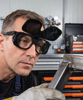 Premium Heavy Duty Industrial Double Lens Welding Goggles featuring anti glare optics, worn by a welder inspecting metal.