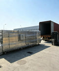Top Shelf Industrial Tunnel Freezer With Sturdy Roller Conveyor Belt ready for shipping outside a processing facility.