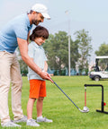 Person teaching child golf using Indoor Golf Swing Trainer With 3 Height Levels Pro Grade Iron Practice Swing Groover on grass