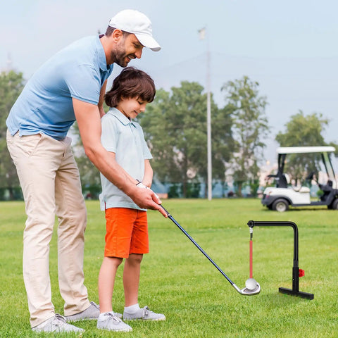 Person teaching child golf using Indoor Golf Swing Trainer With 3 Height Levels Pro Grade Iron Practice Swing Groover on grass
