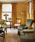 Living room with Tiffany Style Stained Glass Reading Floor Lamp With Antique Arched Tall Design 62 Inch Standing Lamp For Living Room Bedroom Or Office Handcrafted Glass Shade Warm Ambient Light And Vintage Vibe beside armchair.
